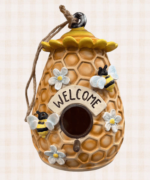 bee themed hanging bird house with a honeycomb beehive and flowers