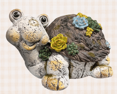 Faux stone turtle for garden with green and blue flowers decorating it's shell